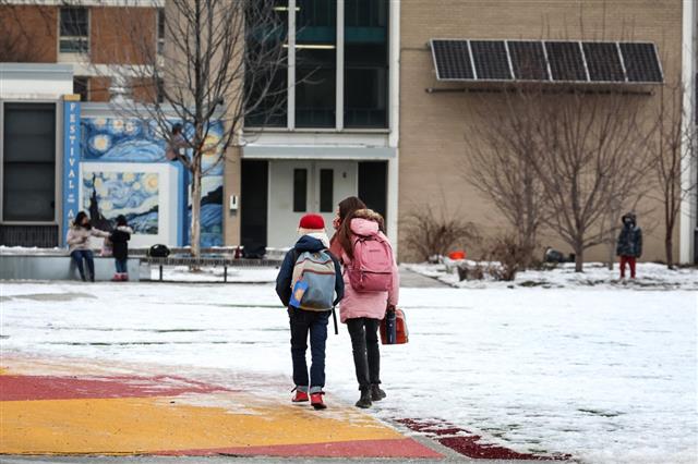   Students approaching school in the snow
